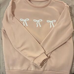 Chic Blush Pink Sweatshirt with White Bow Accents